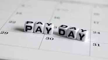 Cubes spell 'PAY DAY' on a calendar