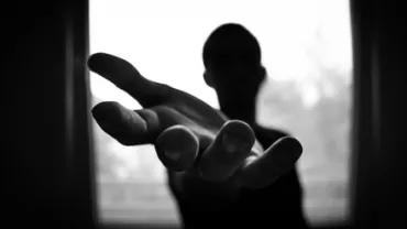 A hand reaching out towards the camera.