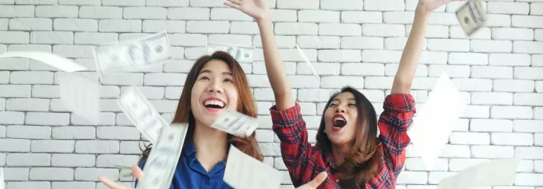 Two people enjoying throwing money in the air.